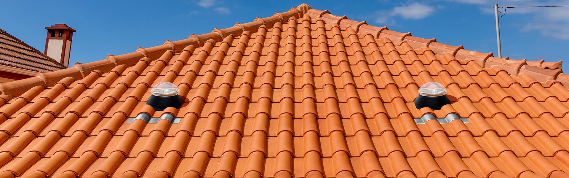 Natural Light tubular skylight on clay tile roof